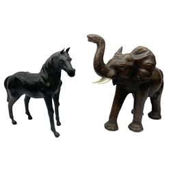 Liberty style dark leather clad model of an elephant, its trunk raised and in standing pose, together with a leather clad model of a horse with cut leather ears, largest example 