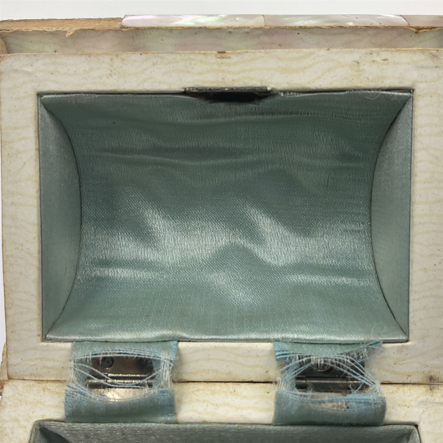 19th century French souvenir jewellery casket in the form of a bathing machine, having mother of pearl panelled tiled effect body, hinged roof/cover revealing a blue silk fitted interior with cushioned base, two silvered metal wheels, abalone shell door and mother of pearl steps, inscribed 'Berck Plage' in blue, H12cm, W13cm 