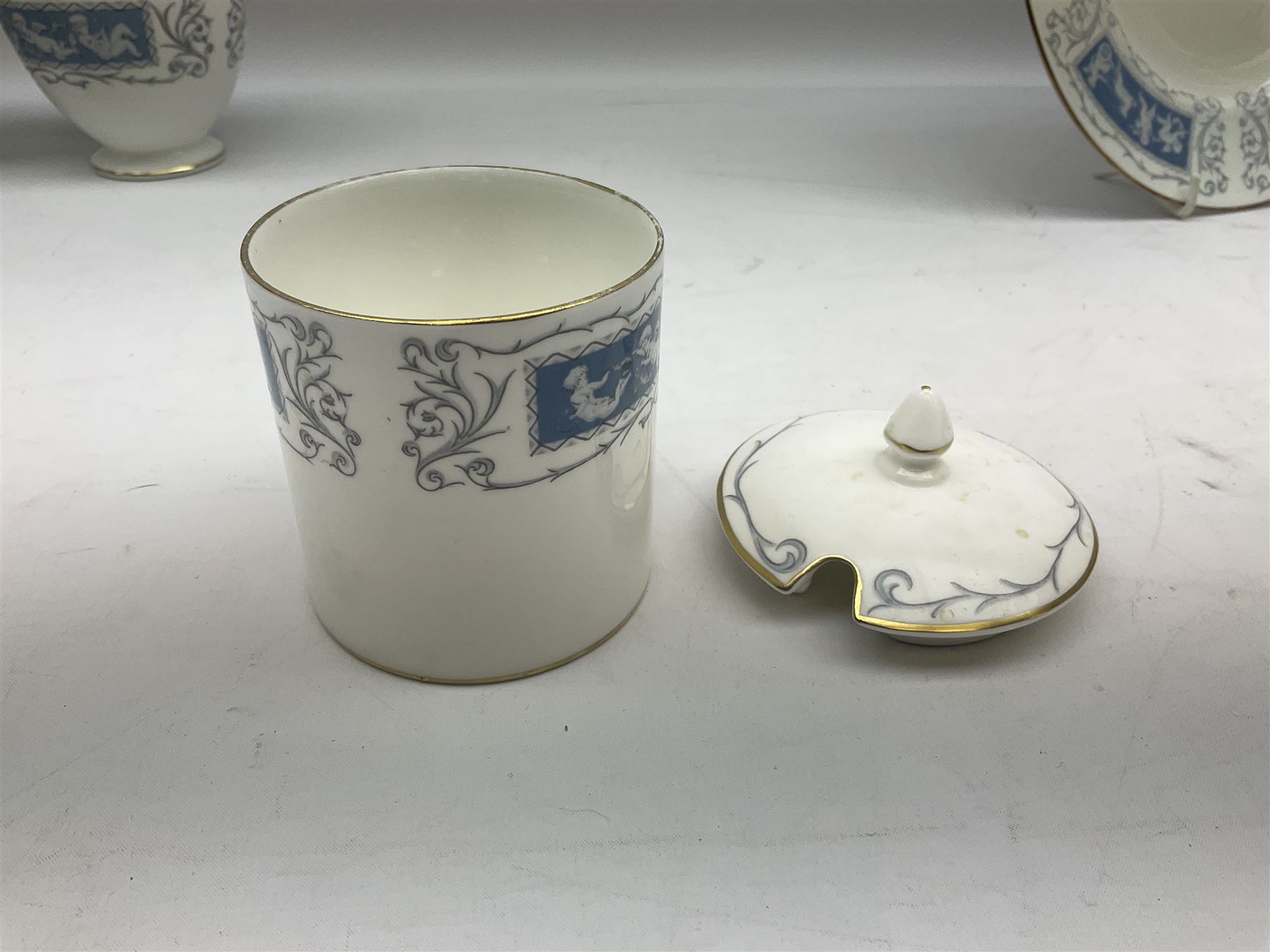 Coalport Revelry pattern tea and dinner wares, comprising nine dinner plates, four salad plates, eleven side plates, sauce boat and stand, ten teacups and ten saucers, and preserve pot and cover, together with a Coalport plate of shaped form decorated with pink roses, and a Royal Crown Derby Royal Antoinette pattern trio