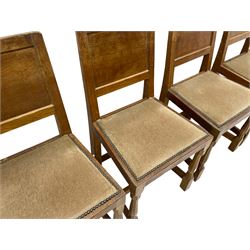 'Eagleman' set four oak dining chairs, adzed panelled backs, upholstered seats with stud work band, the side rails relief carved with inset eagle signature, shaped octagonal supports joined by stretchers, by Albert Jeffray of Sessay, Thirsk