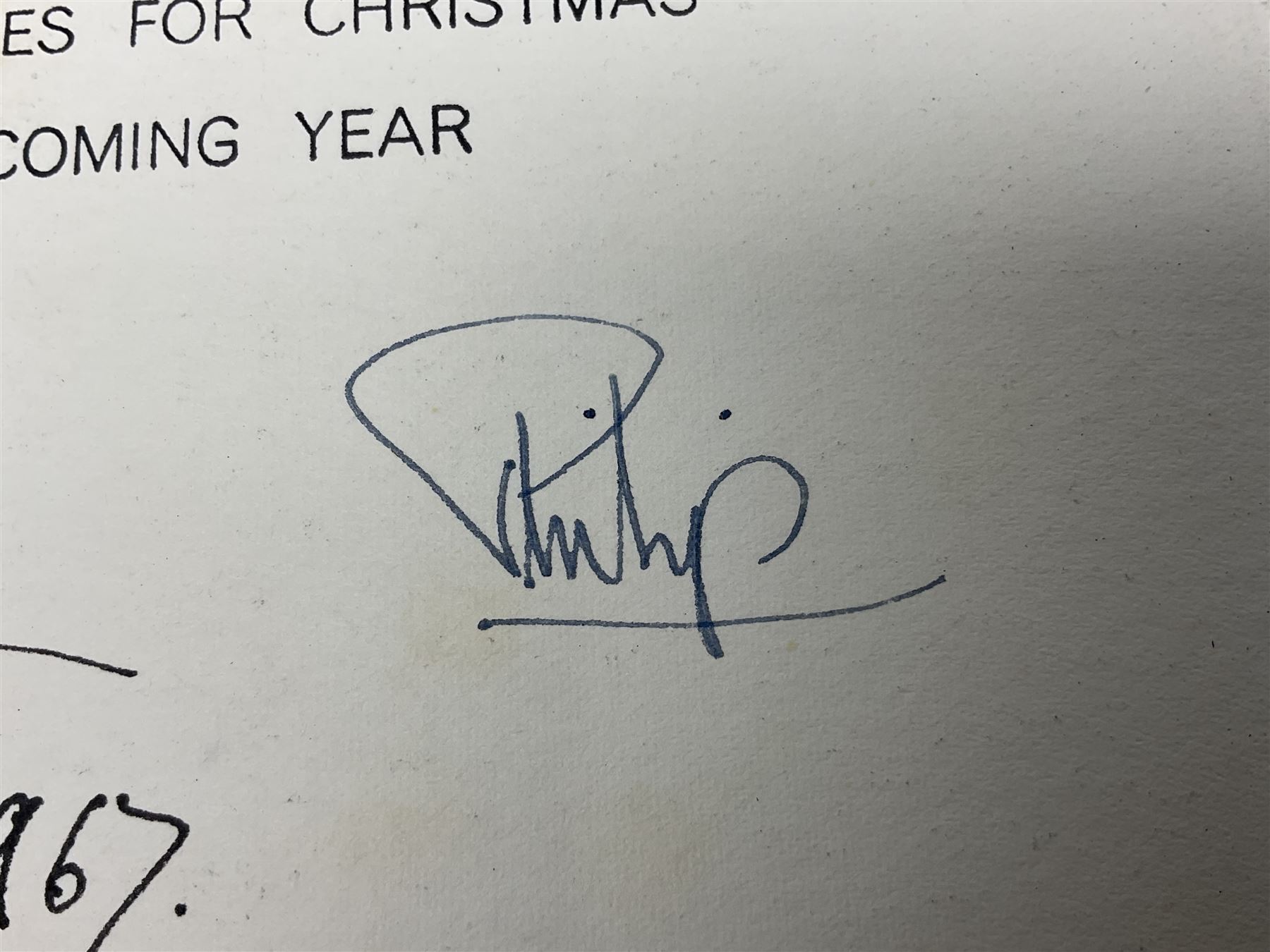 HM Queen Elizabeth II and HRH the Duke of Edinburgh, 1967 Christmas card with two gilt cyphers to front, tipped-in colour print of the Royal Family standing under an archway in Buckingham Palace, signed Elizabeth R and Philip with manuscript date 1967 below