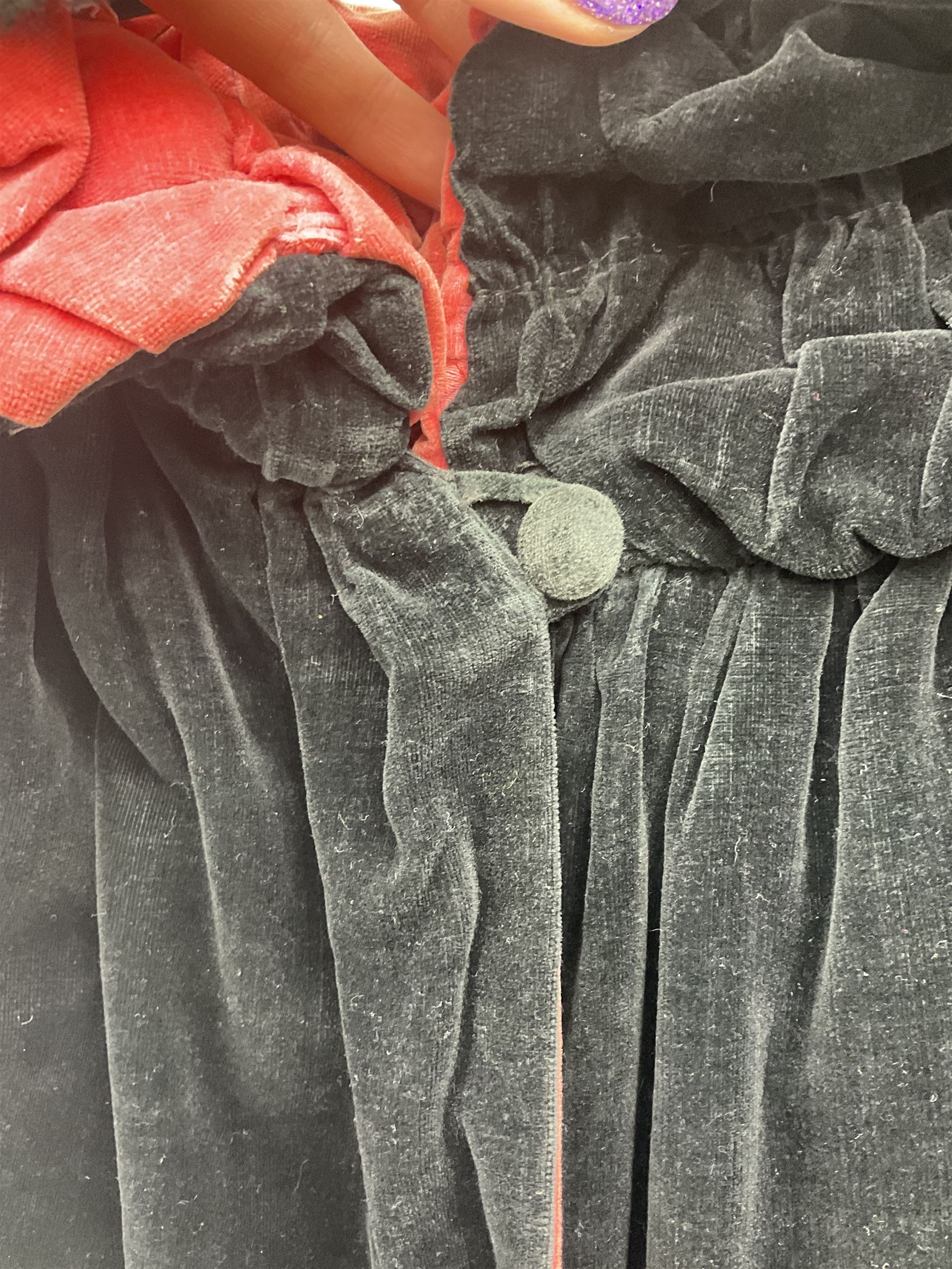 Full length 1930's childs black velvet cape, with ruched collar and red velvet lining, with a single button neck fastening 