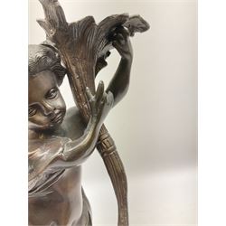Bronzed putti figure holder a floral trumpet, upon a circular plinth, H40cm.  