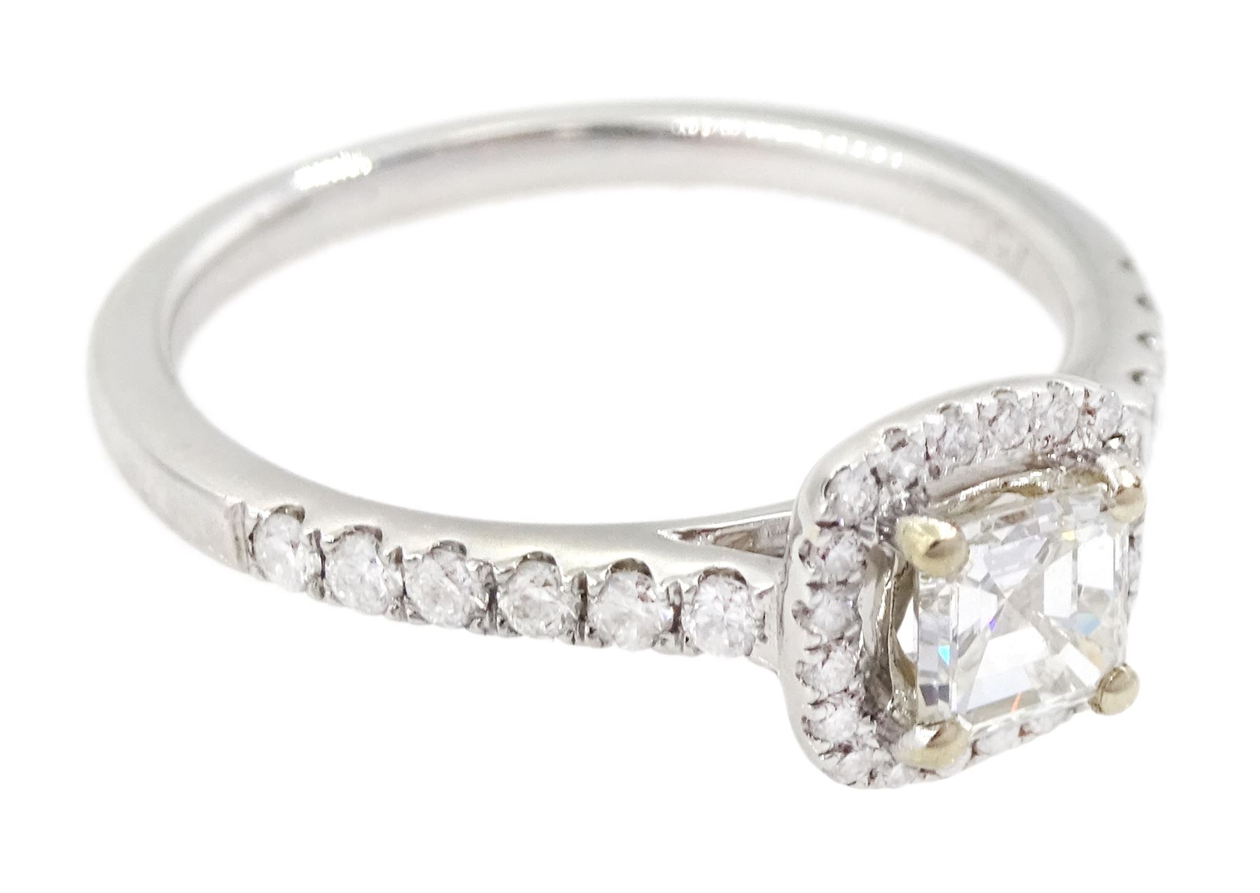 18ct white gold diamond halo cluster ring, the principal asscher cut diamond of 0.39 carat, with round brilliant cut diamond surround and diamond set shoulders, hallmarked, with International Gemological Laboratories report