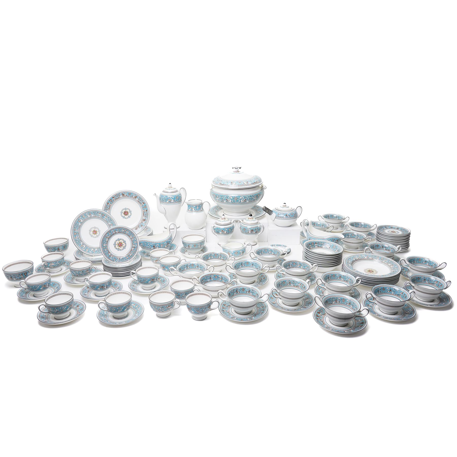 Wedgwood turquoise Florentine part service, comprising large covered tureen and stand, coffee pot, teapot, two covered sucriers, milk jug, two sauce boats and stands, seven soup plates, three bowls, jug, eighteen soup bowls and fifteen stands, two ashtrays, thirteen further saucers, twelve teacups and eleven saucers, and twenty-one further plates of varying sizes