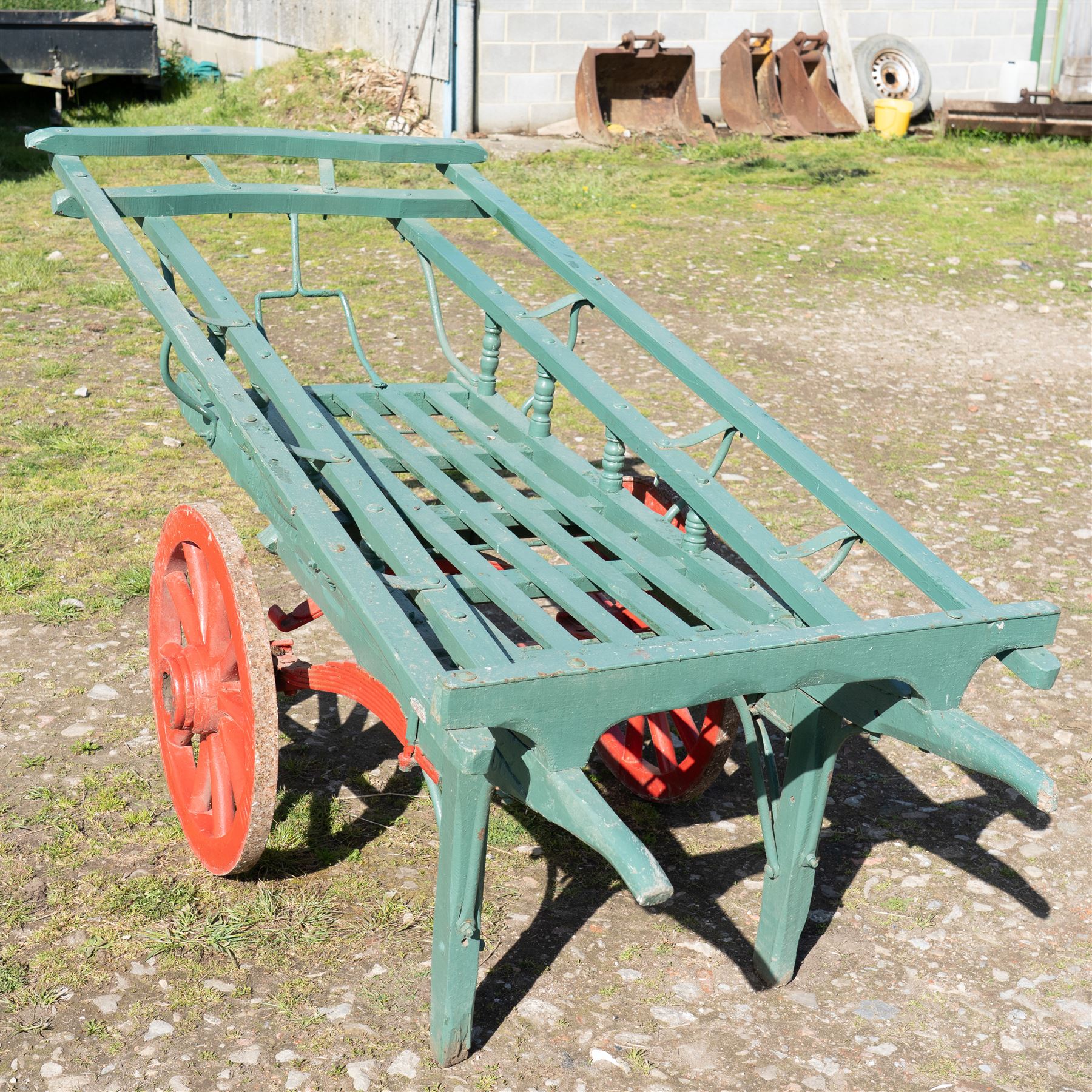 Costermonger’s Cart

A painted costermonger’s cart with green slatted timber body, red painted wooden spoked wheels and red leaf spring suspension. The cart is fitted with raised side rails, turned supports and short projecting handles. Painted lettering is visible along the side rails, together with the number “661” to the frame and wheel rim.
Finished in traditional colours, the cart offers excellent decorative appeal and would be suitable for display, garden or country house settings.

Dimensions:
Overall length: 240 cm
Body length: 215 cm
Width: 94 cm
Height: 86 cm
Wheel diameter: 64 cm

Features:
Timber construction
Open slatted carrying platform
Shaped side rails
Leaf spring suspension
Wooden spoked wheels
Iron tyres
Iron fittings throughout
Carved ownership and maker inscriptions
Traditional painted finish

