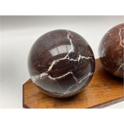 Set of three marble spheres on a elongated octagonal wooden base, H12cm