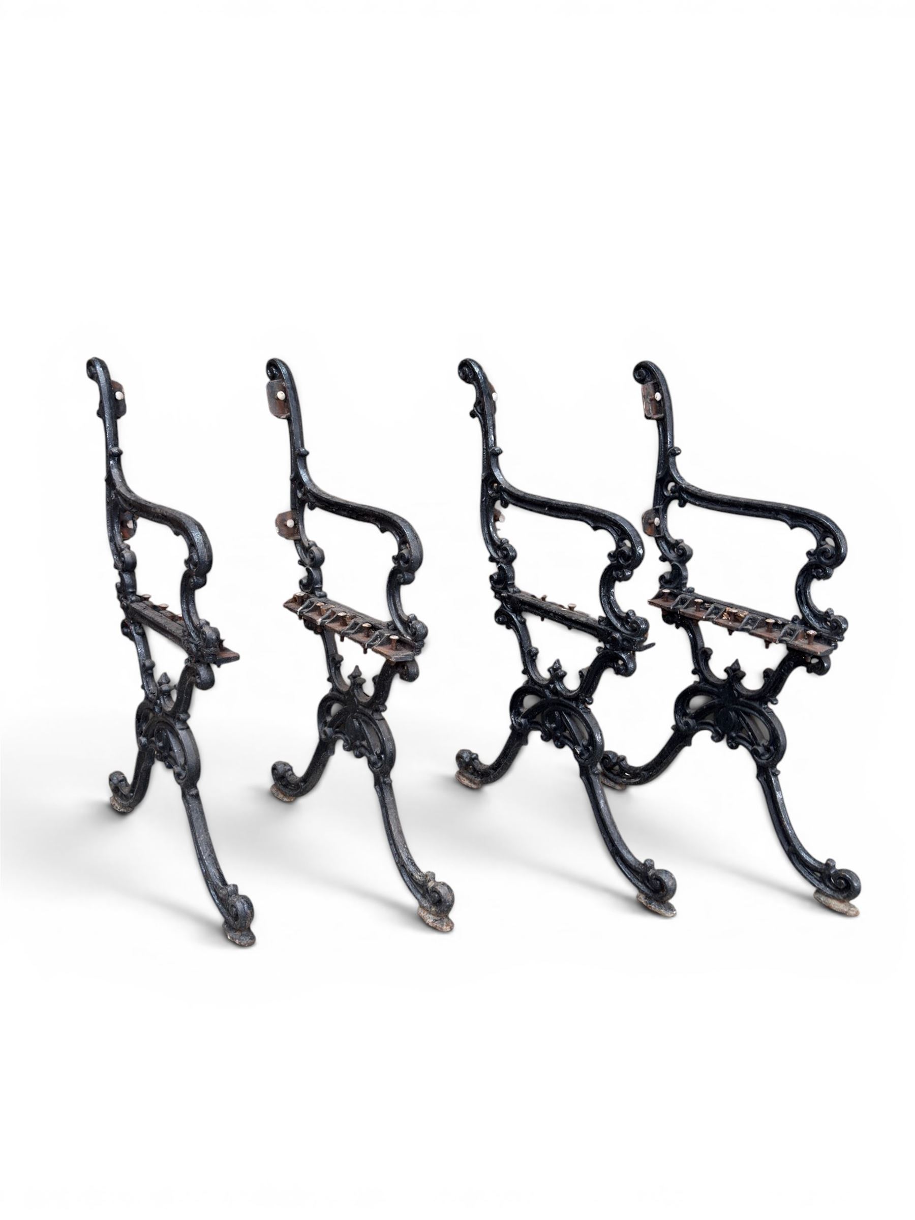 Carron Foundry - two pairs of 19th century cast iron garden bench ends, ornate detail with arms and X shaped legs,finish in black paint, the design no. 110396, first registered 13 July 1857 (see illustration), width as desired