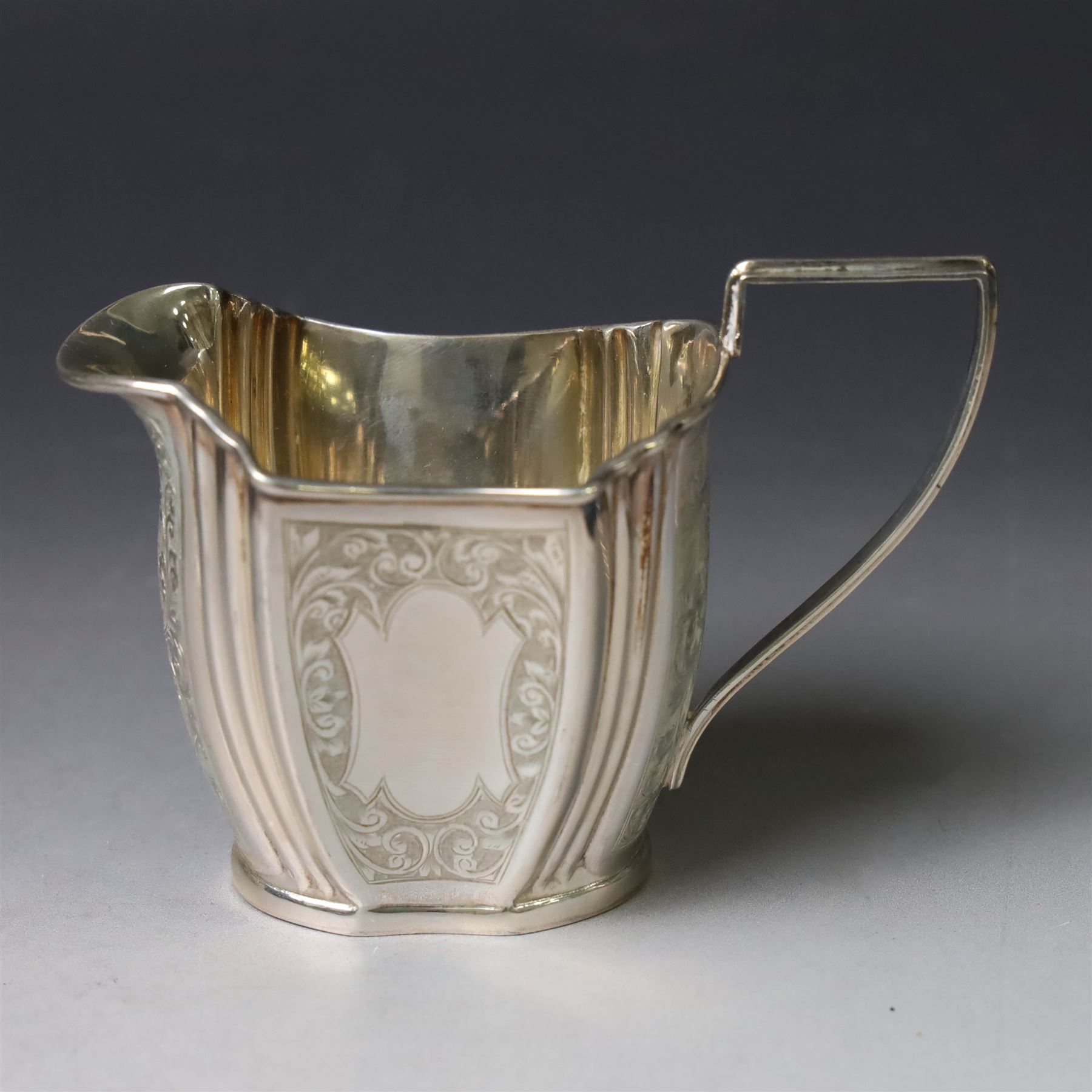 Late Victorian silver twin handled open sucrier and milk jug, of fluted form with panels of engraved foliate decoration, hallmarked D & M Davis, London 1896