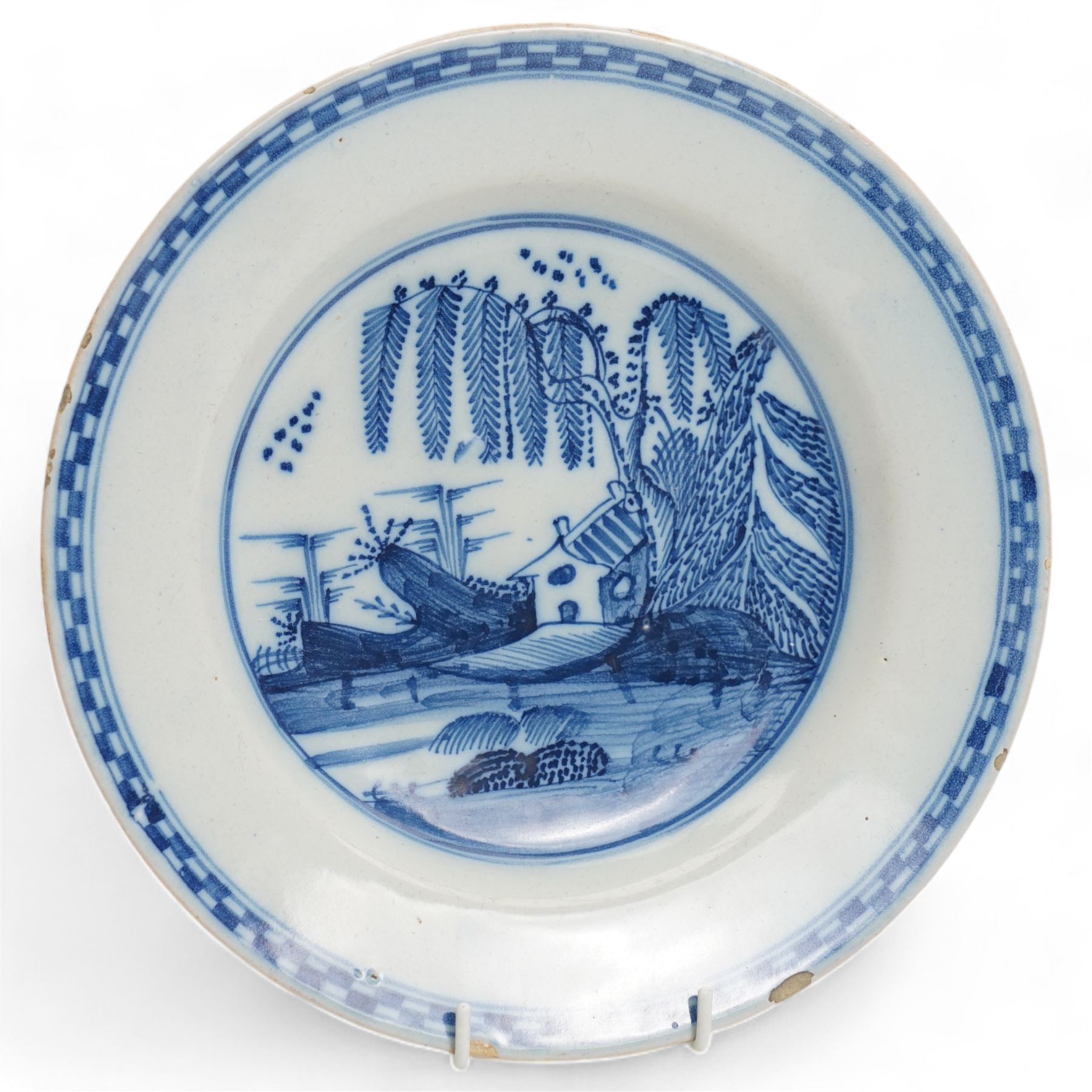 18th century Delft plate decorated with a Chinoiserie landscape