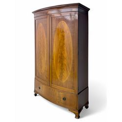 Early 20th century mahogany bowfront double wardrobe, dentil-moulded cornice over twin doo...