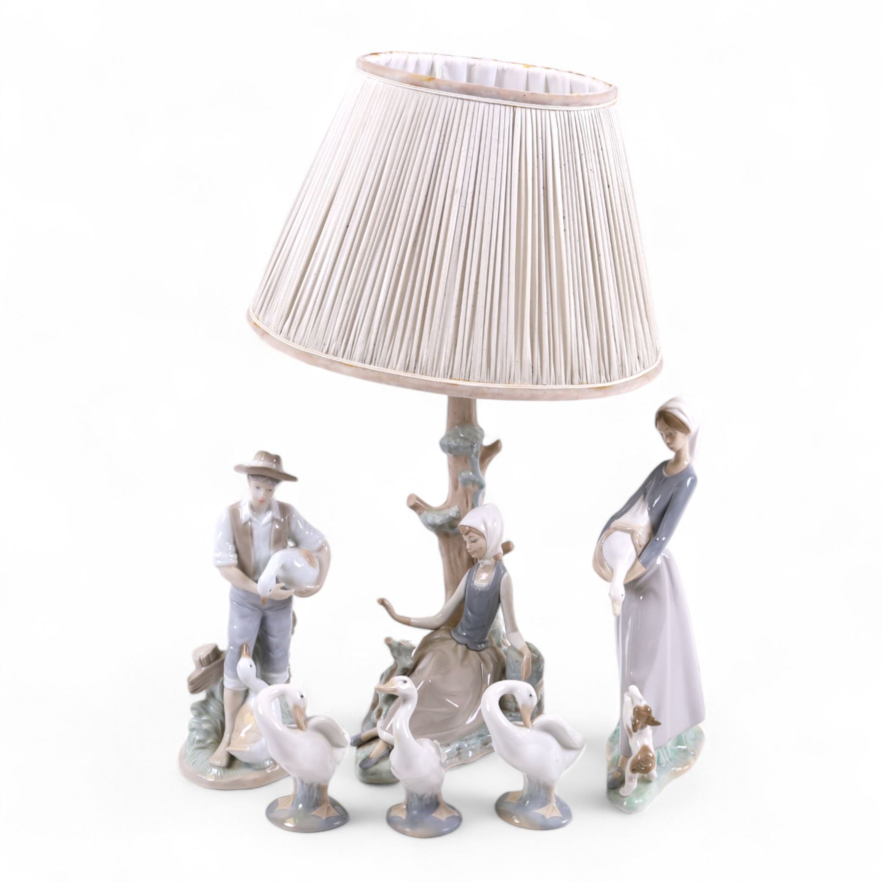 Lladro lamp, modelled as a girl beneath a tree together with four Lladro figures and one other 
