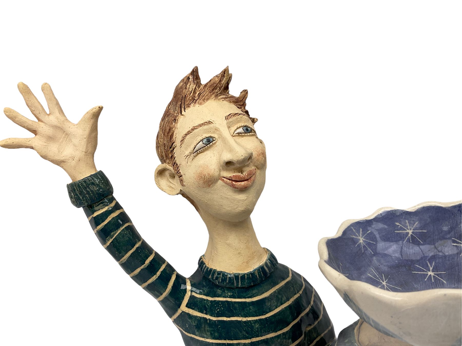 Ceramic 'girl and boy dish', by Helen Kemp, an oval dish with a mottled pink ground and gilt edging upon the sculpted heads of a girl and a boy, together with a 'boy sconce', by Helen Kemp, a sculpted boy holding a small bowl with foliate decoration, both with the artist's mark beneath.