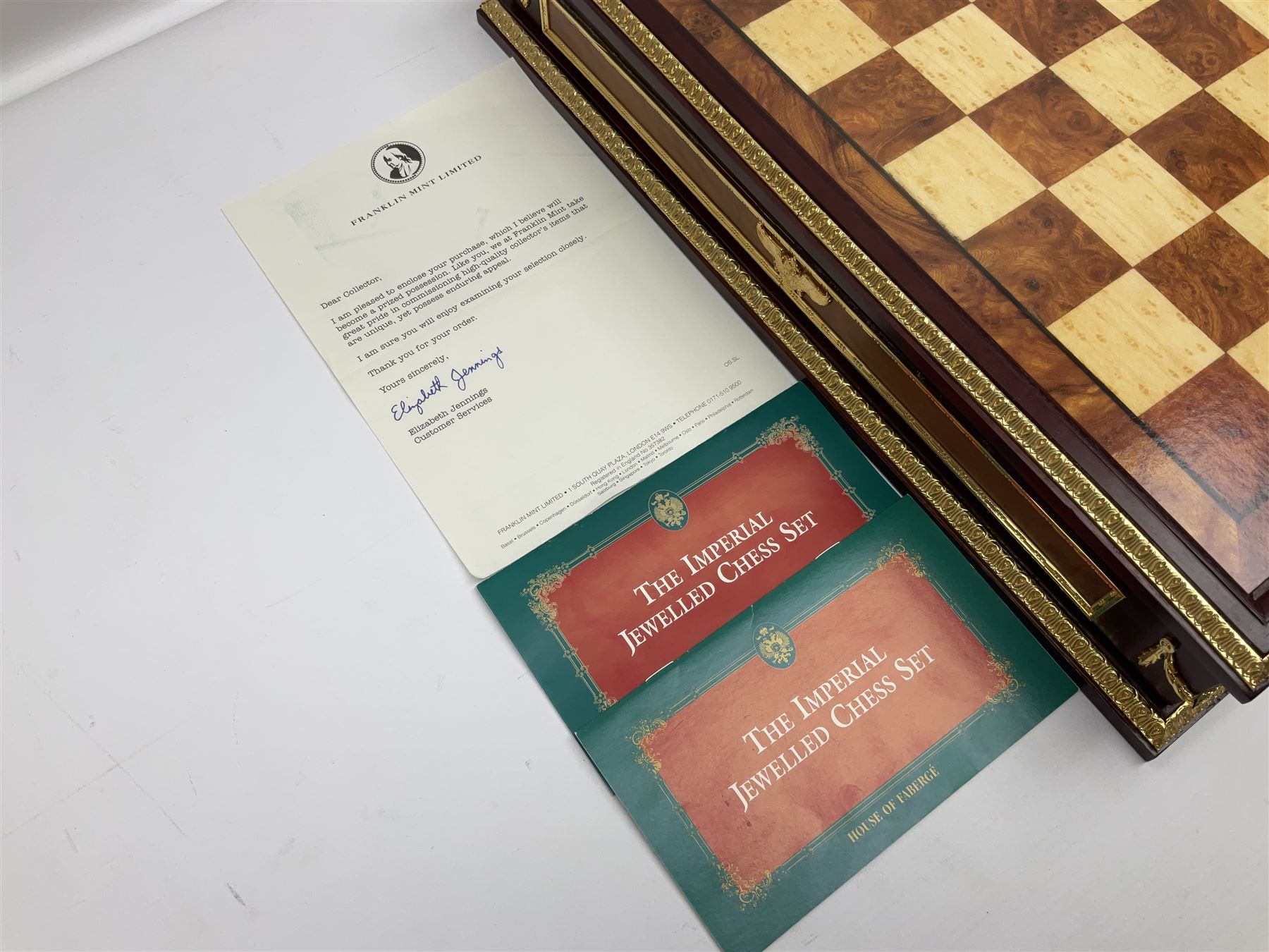 Franklin Mint House of Faberge 'The Imperial Jewelled Chess Set', to include set of chess pieces with malachite finish and a set with carnelian finish and a hardwood chess board