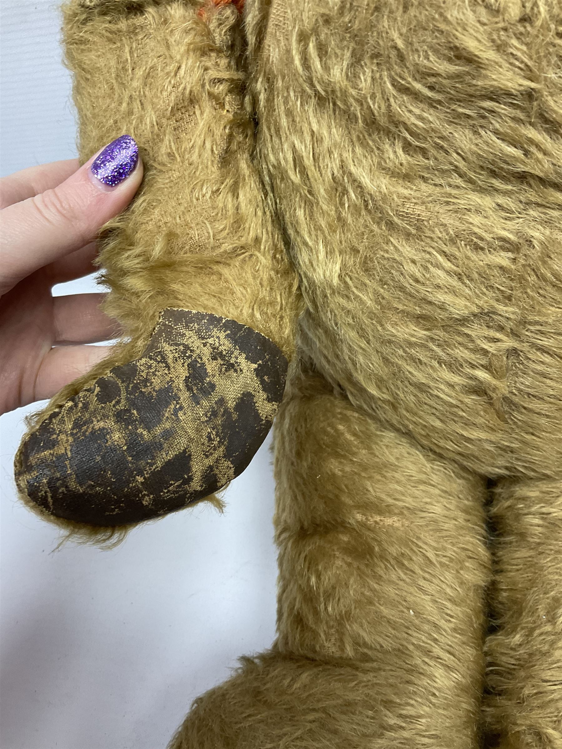 Mid-20th century plush covered teddy bear the revolving head with applied eyes, vertically stitched nose and jointed limbs with rexine pads H58cm; together with a leather backpack (2)