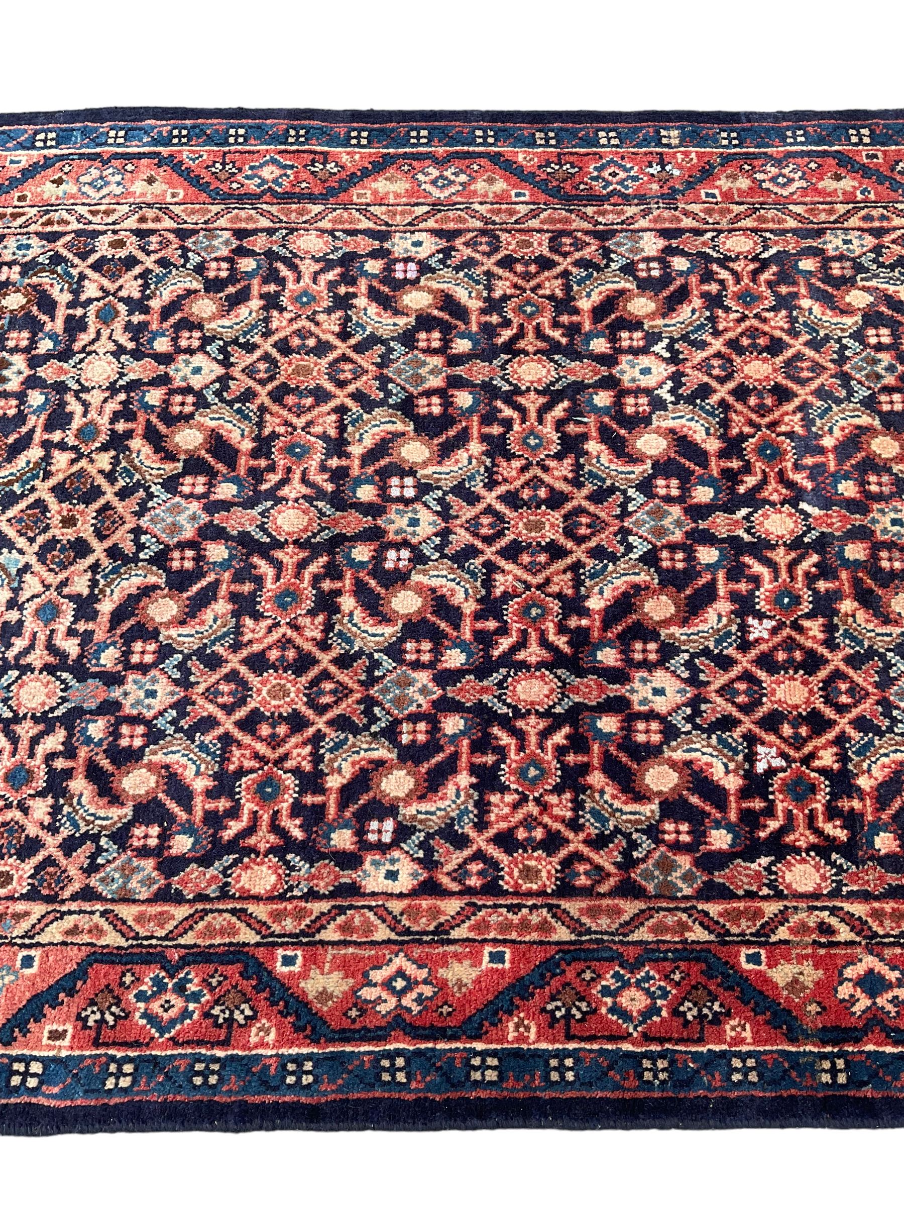 North West Persian Mahal indigo ground runner rug, the field decorated with all-over crimson Herati motifs, the guarded border with trailing geometric designs