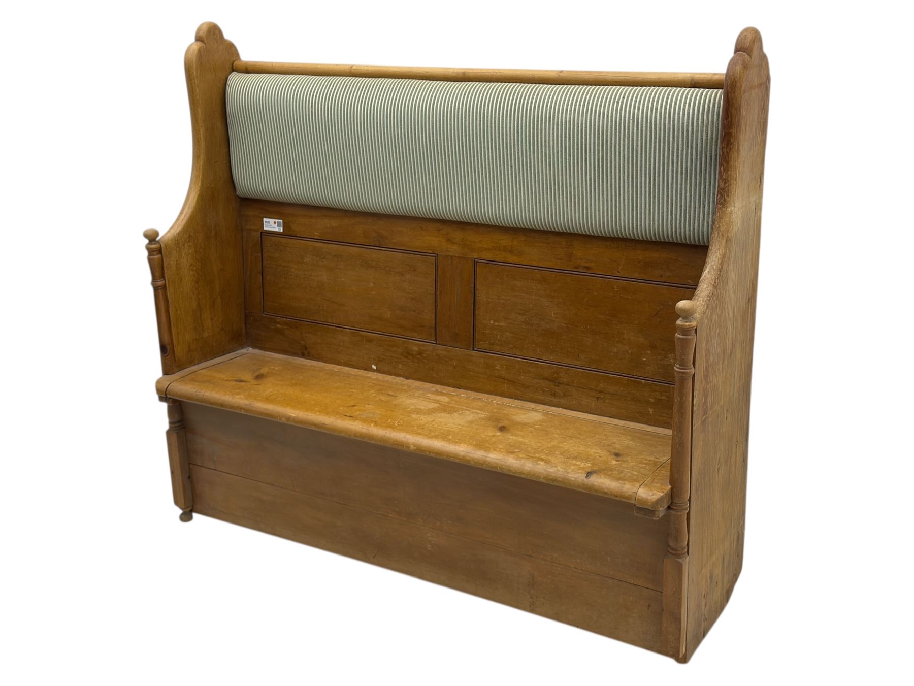 Early 20th century waxed pine pew, inset upholstered striped back panel with hinged box seat enclosing storage, shaped arms and turned supports