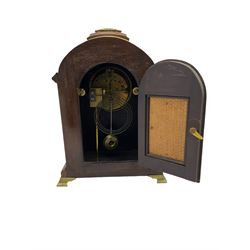 An early 20th century “Walker & Hall” 8-day mantle clock with a French striking movement striking the hours on a coiled gong, in a mahogany break arch case with carrying handle, silk backed side frets and canted reeded corners, raised on bracket feet, enamel dial with Arabic numerals, minute track and steel spade hands. With pendulum.


