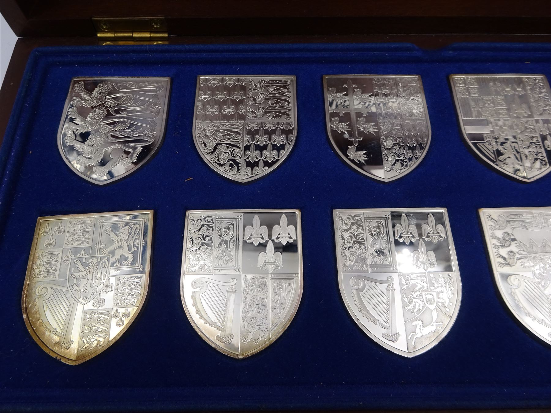 Yorkshire Mint, The Royal Arms Collection, twelve shield shaped silver medallions each depicting variations on the Royal coat of arms, each hallmarked Yorkshire Mint, Birmingham 1976/77, contained within fitted wooden case with associated information cards
