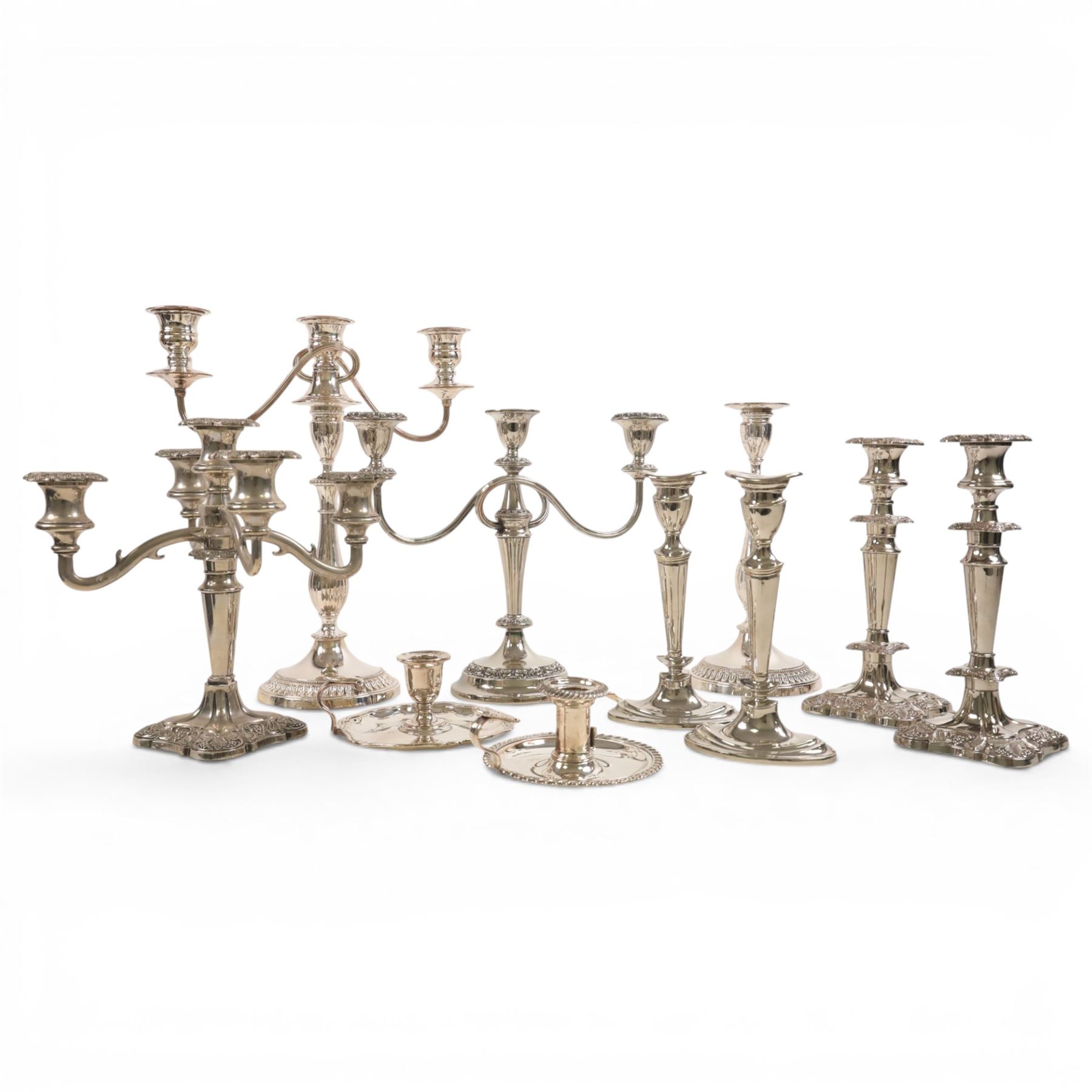 Silver plate two branch candelabra with grape vine decoration to the base, together with a matching pair of candle sticks and other candlesticks  