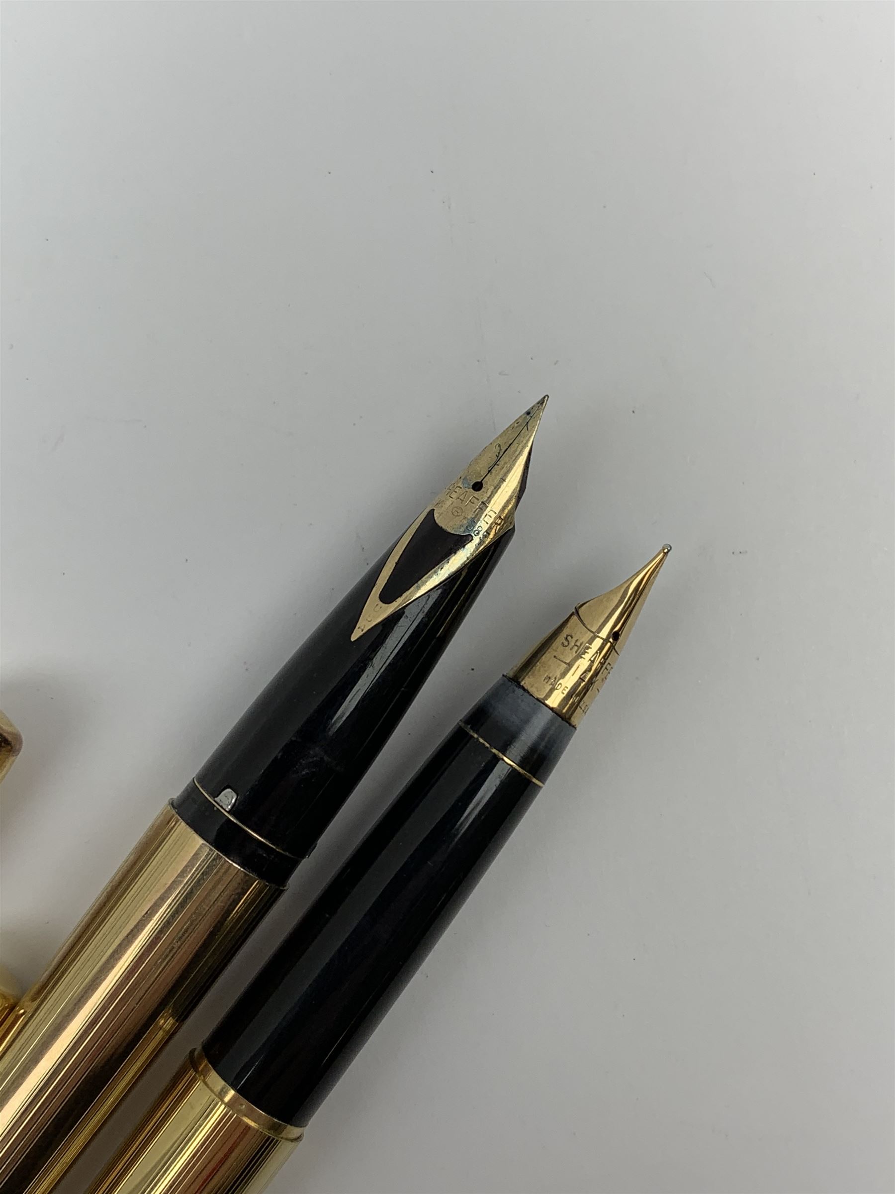 A Sheaffer Imperial Triumph fountain pen, the electroplated body with vertical band decoration, and nib marked 14K 585, together with a further Sheaffer fountain pen, with similarly decorated electroplated body, and nib marked 14K, in unassociated case. 