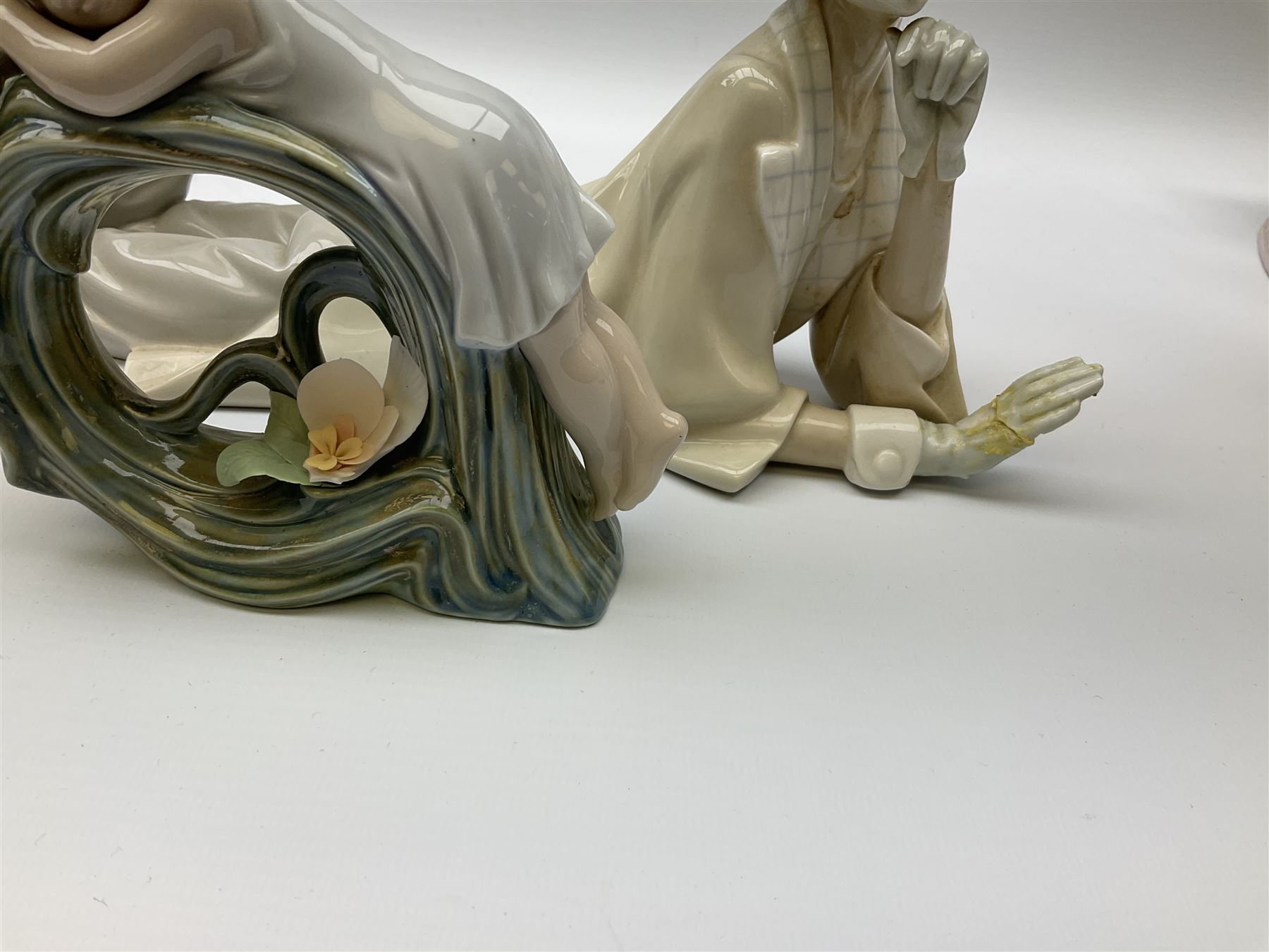 Collection of seven Lladro figures, including Seated ballerina with swan 6204, Childhood Dream 8129, Dancer 5050, reclining clown with ball alongside a selection of other figures. 