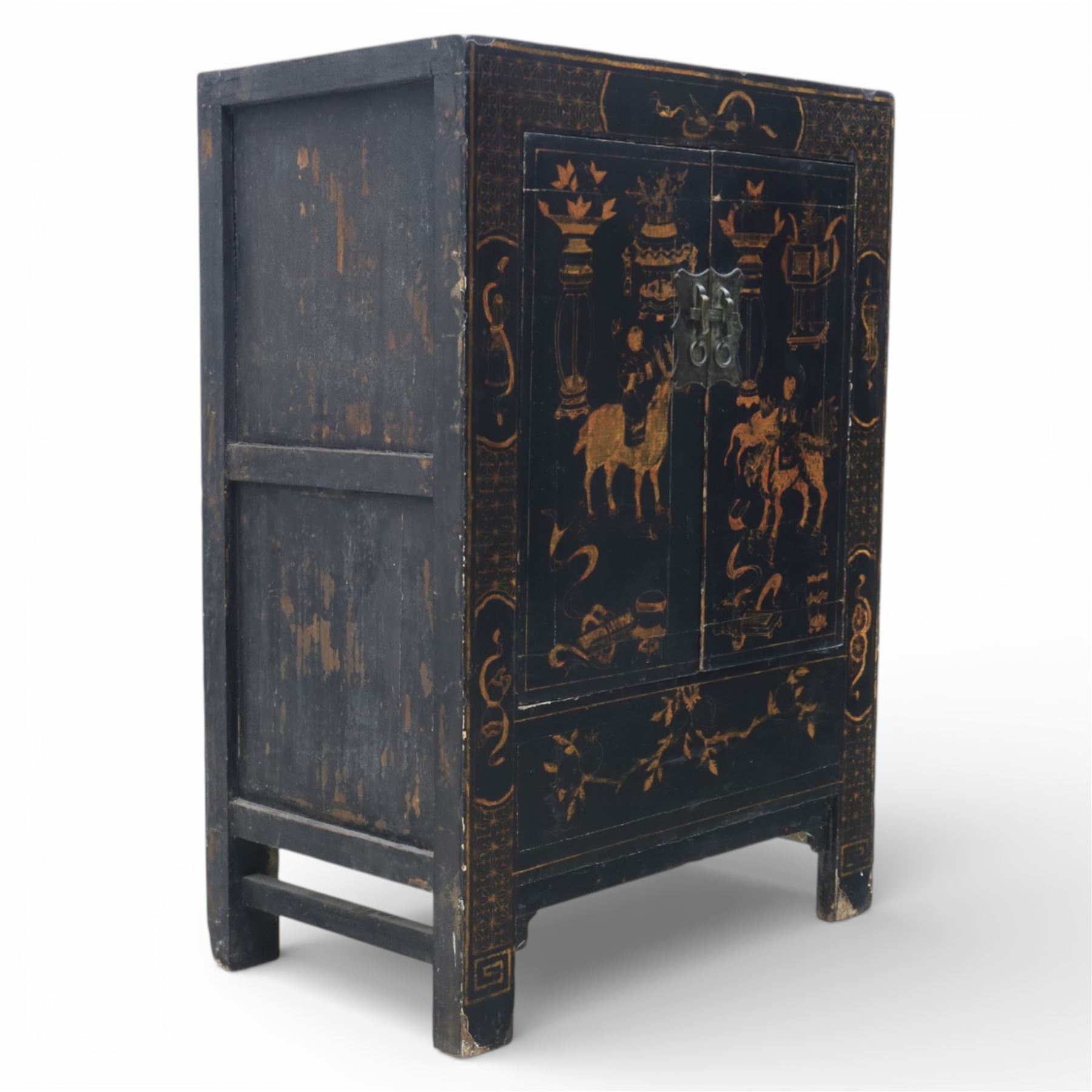19th century Chinese black lacquer marriage cabinet, rectangular form, twin cupboard doors painted with gilt chinoiserie scenes depicting mounted figures, ritual urns and symbolic objects within patterned borders, central shaped metal lock plate with twin drop handles, lower section decorated with fruiting sprays, standing on stile supports