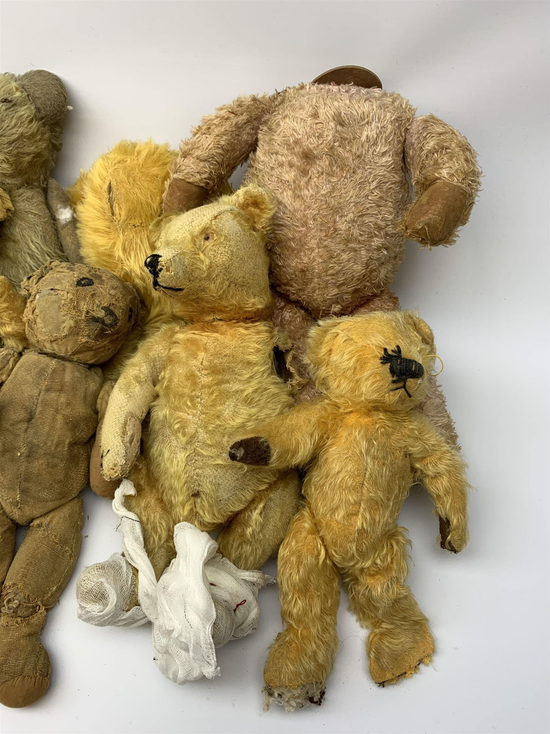 Quantity of early wood wool filled teddy bears for restoration.