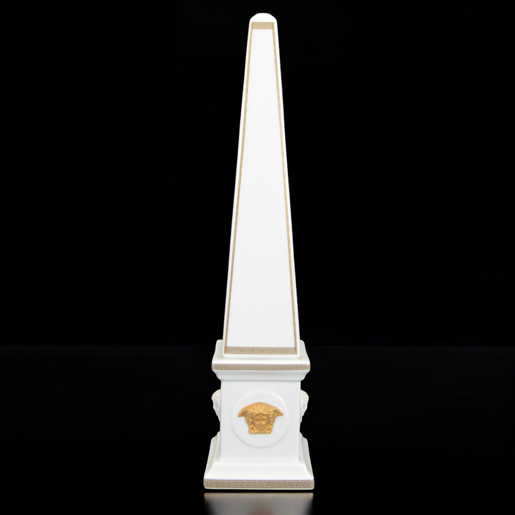 Pair of Rosenthal Versace Gorgona obelisks, each with relief moulded Medusa masks and gilt Greek key borders upon a white ground, both boxed, H38cm