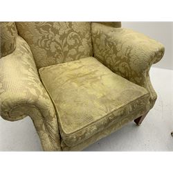 Duresta - pair beech framed wingback armchairs, upholstered in pale gold fabric decorated with raised floral pattern, feather loose cushions, square tapering front supports with brass castors, splayed rear supports 