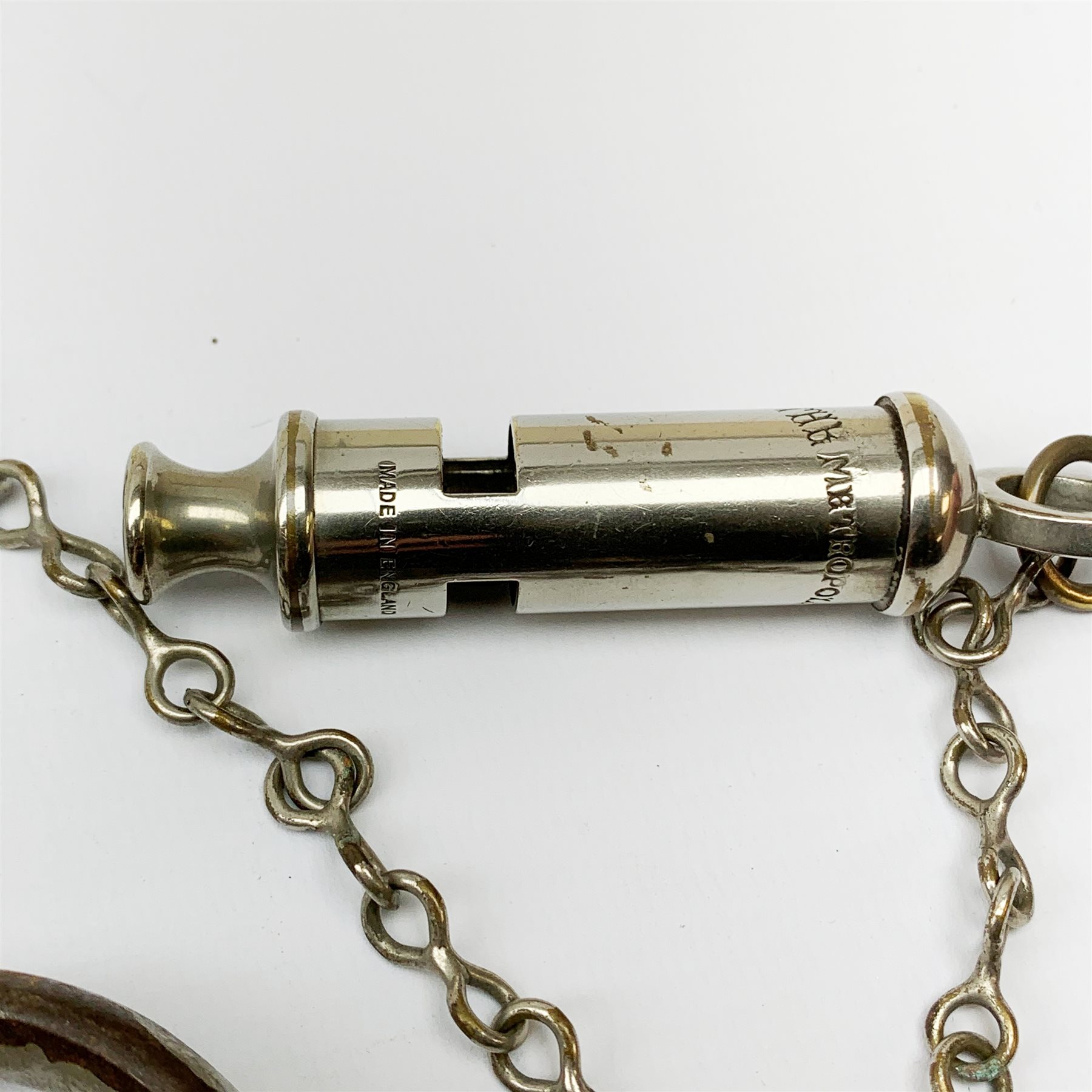Pair of 1920's Hiatt nickel plated handcuffs marked 'Warranted Wrought' with screw-in key and a 'Metropolitan' whistle