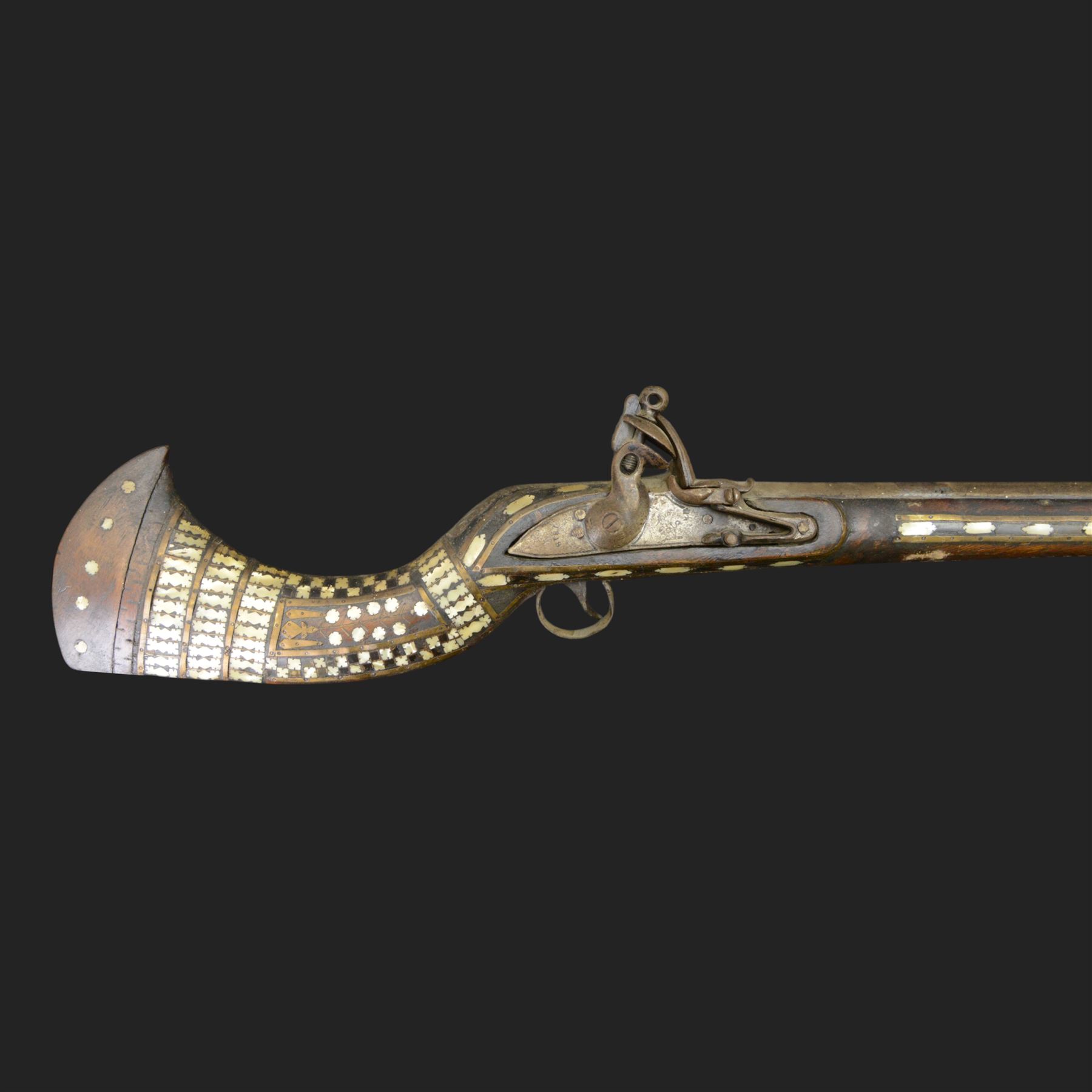 Indian Jezail style flintlock musket, with 118cm barrel, the East India Company lock marked 1818,  the curved butt inlaid with mother of pearl and brass decoration, overall L155cm
