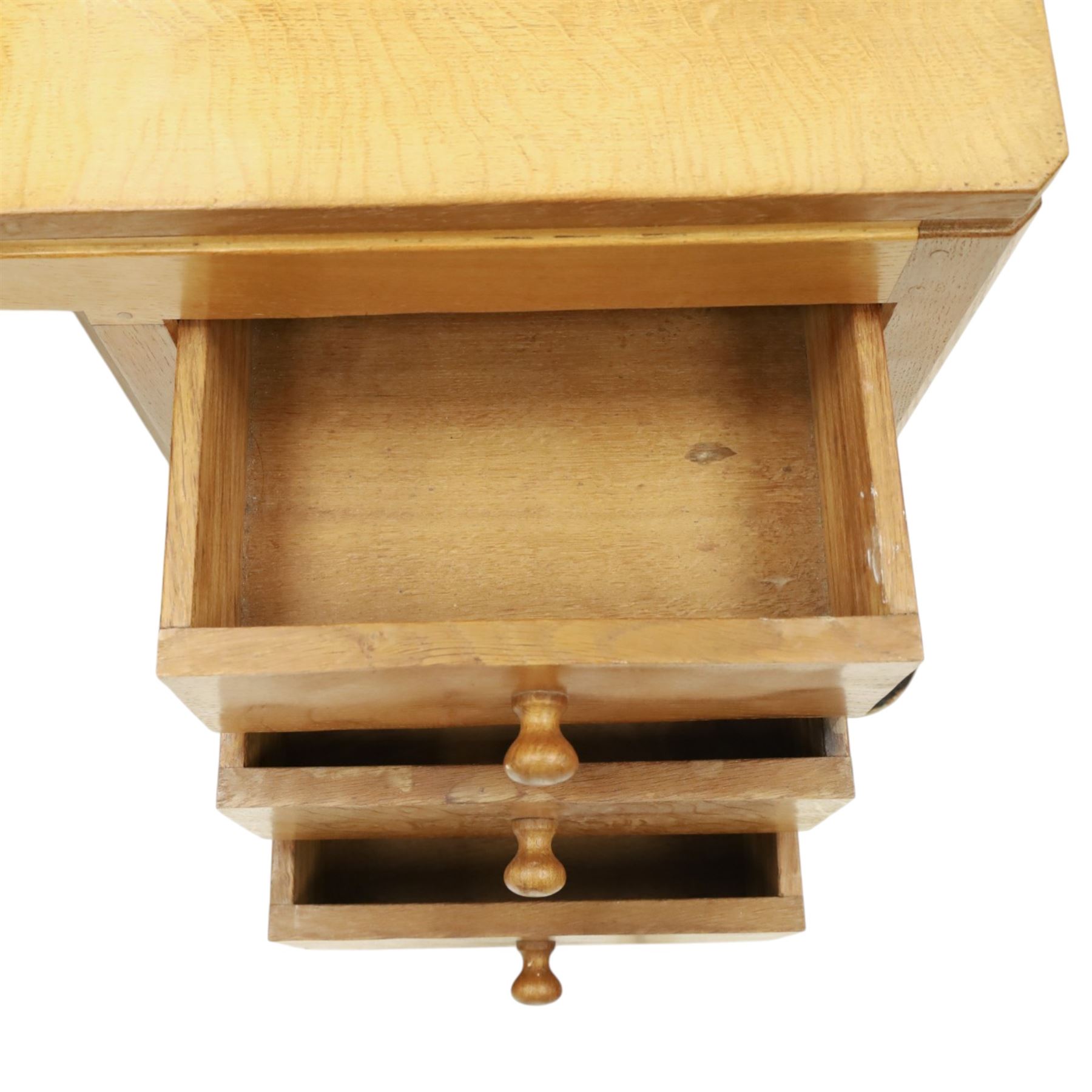 Mouseman - adzed oak kneehole dressing table with mirror, the rectangular adzed top with raised back and canted corners with fixed central pivoting mirror with scallop-carved cresting rail, over an arched recessed kneehole flanked by three graduating drawers to each side with turned knob handles, raised on octagonal feet, with carved mouse signature, by the workshop of Robert Thompson of Kilburn