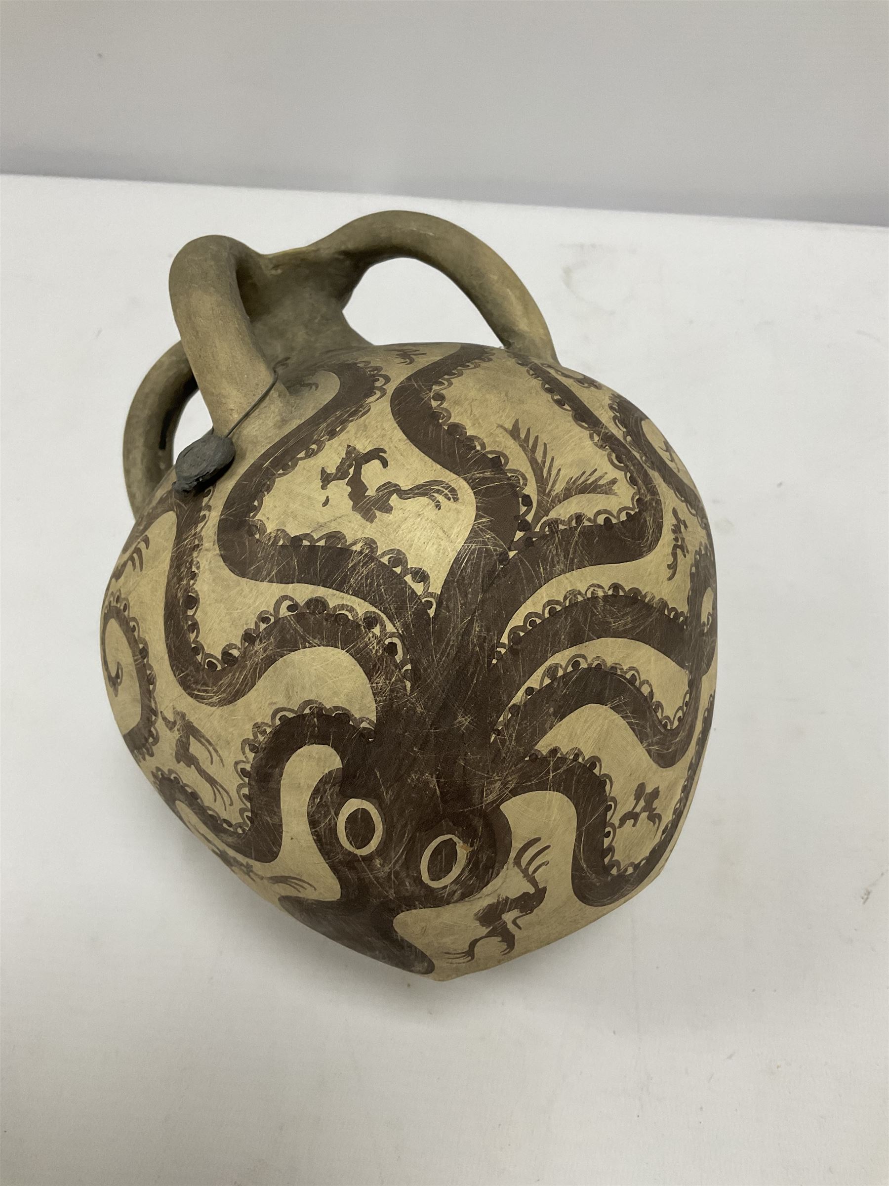 Reproduction Ancient Greek vessel in the style of Crete Minoan period, decorated with marine style ocotopi, with three handles and spout, signed beneath, H20cm