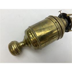 Brass oil lamp with wall bracket modelled with a fish
