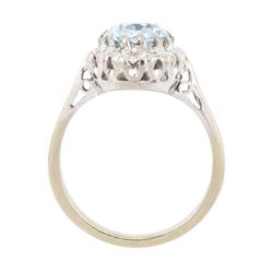 White gold aquamarine and diamond cluster ring, oval cut aquamarine of approx 1.35 carat, with single cut diamond surround, stamped 18ct