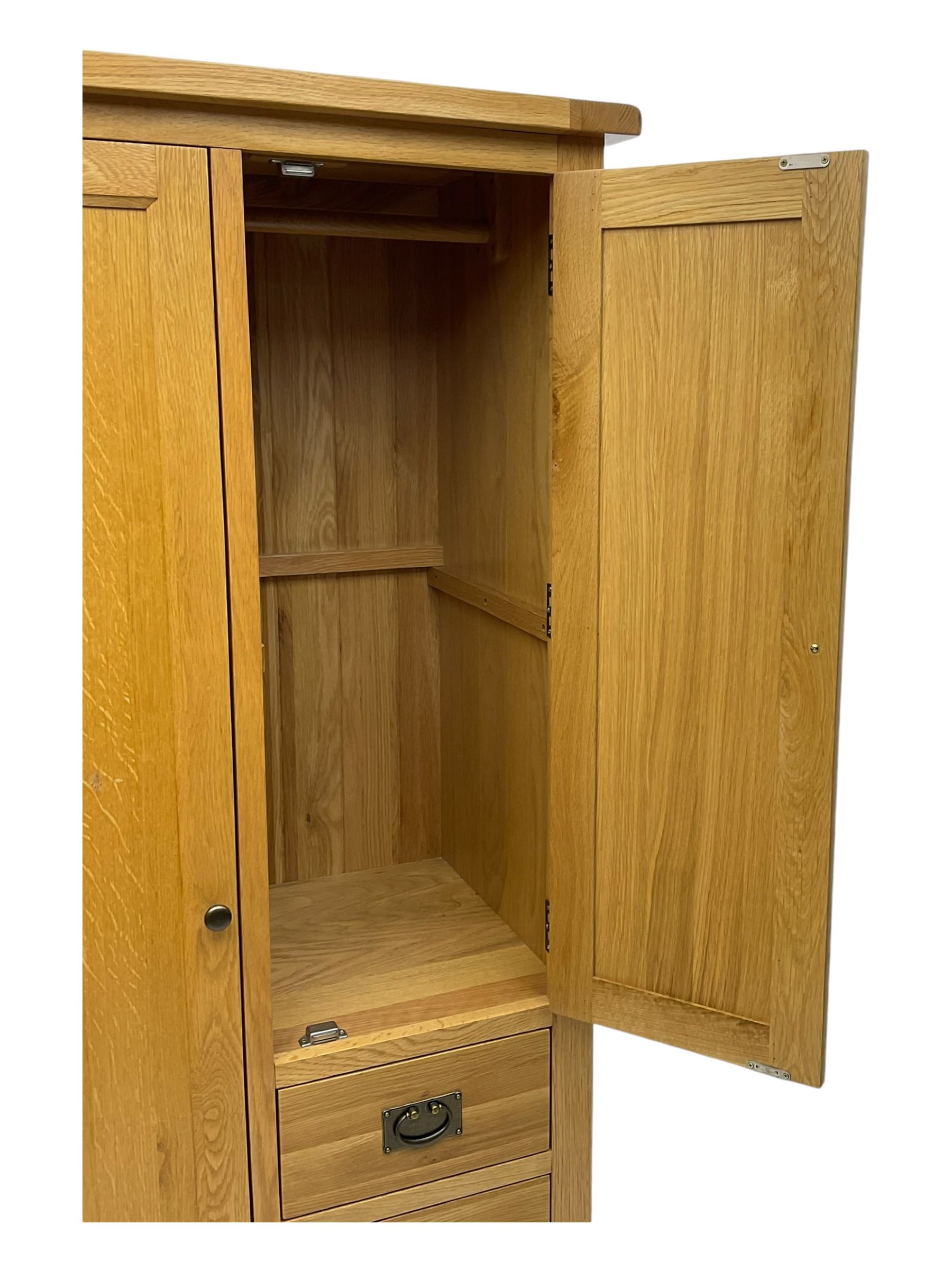 Light oak combination wardrobe, fitted with full-height compartment, single cupboard and three small drawers