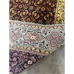 Persian Mahal rug, the blue ground field decorated with repeating Herati motifs, guarded pale ground border decorated with stylised panels