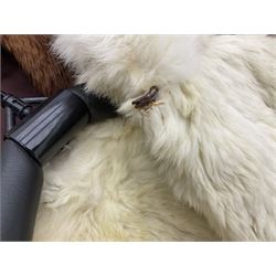 Brown mid length musquash fur coat by National Fur Company together with white rabbit cape