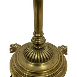 Edwardian brass plated copper standard lamp, telescopic stem on lobe moulded circular base with three projecting paw feet, with cream shade