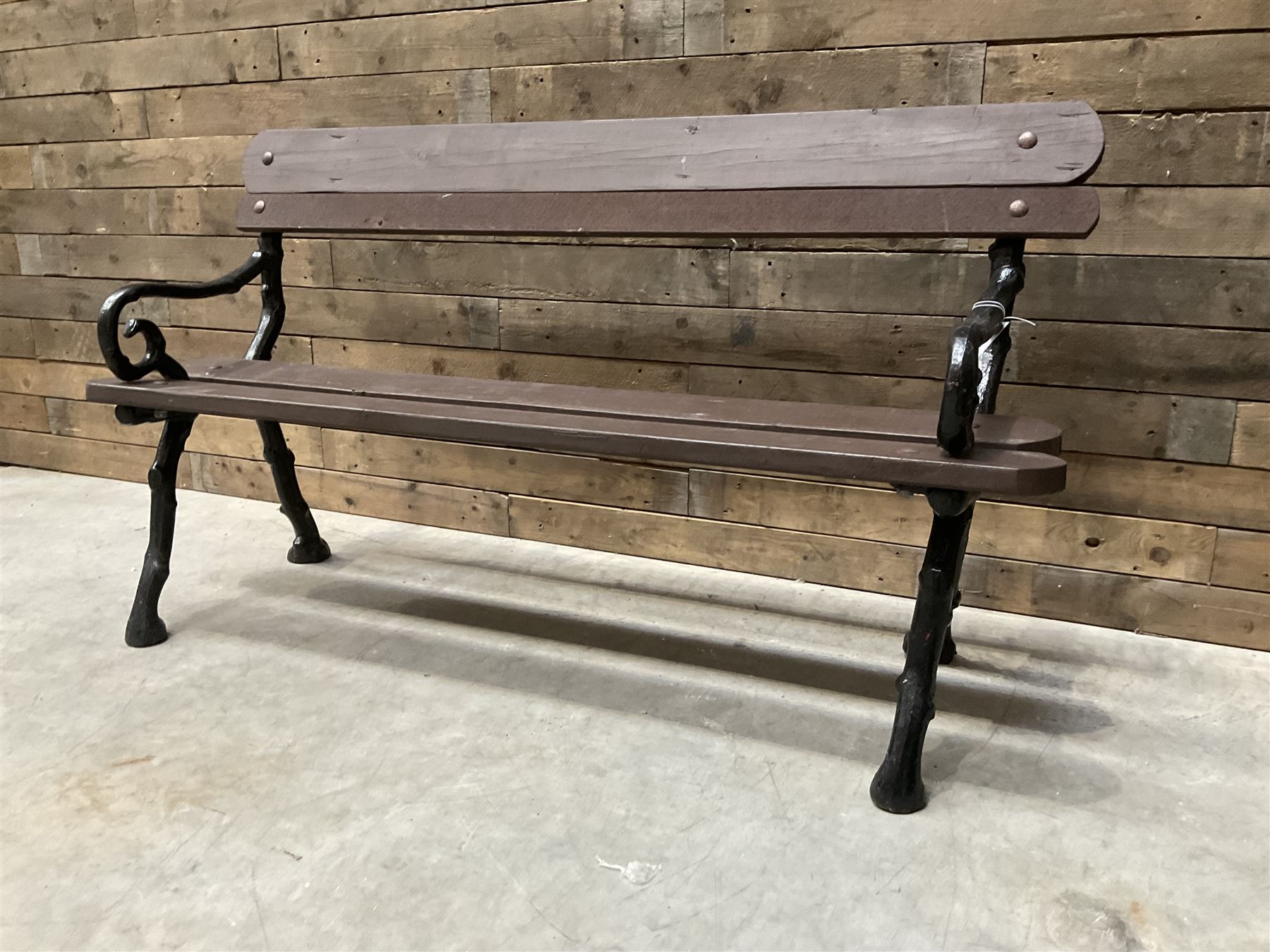 20th century tree cast iron and timber slatted garden bench, black painted frame with stained wood