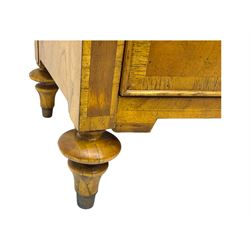 Frank Hudson - mid-20th century Mindi ash and burr walnut 'Spire' bow-fronted chest, featuring a crossbanded top over two short and three long cockbeaded drawers, raised on turned supports  