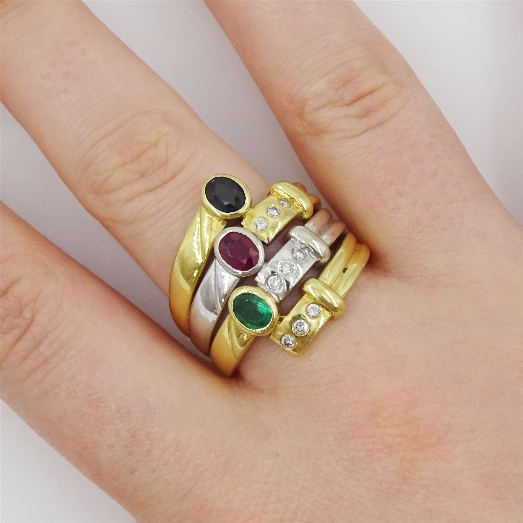 18ct gold multi gemstone set ring, four white and yellow gold rows set with an oval cut sapphire, ruby and emerald and round brilliant cut diamonds