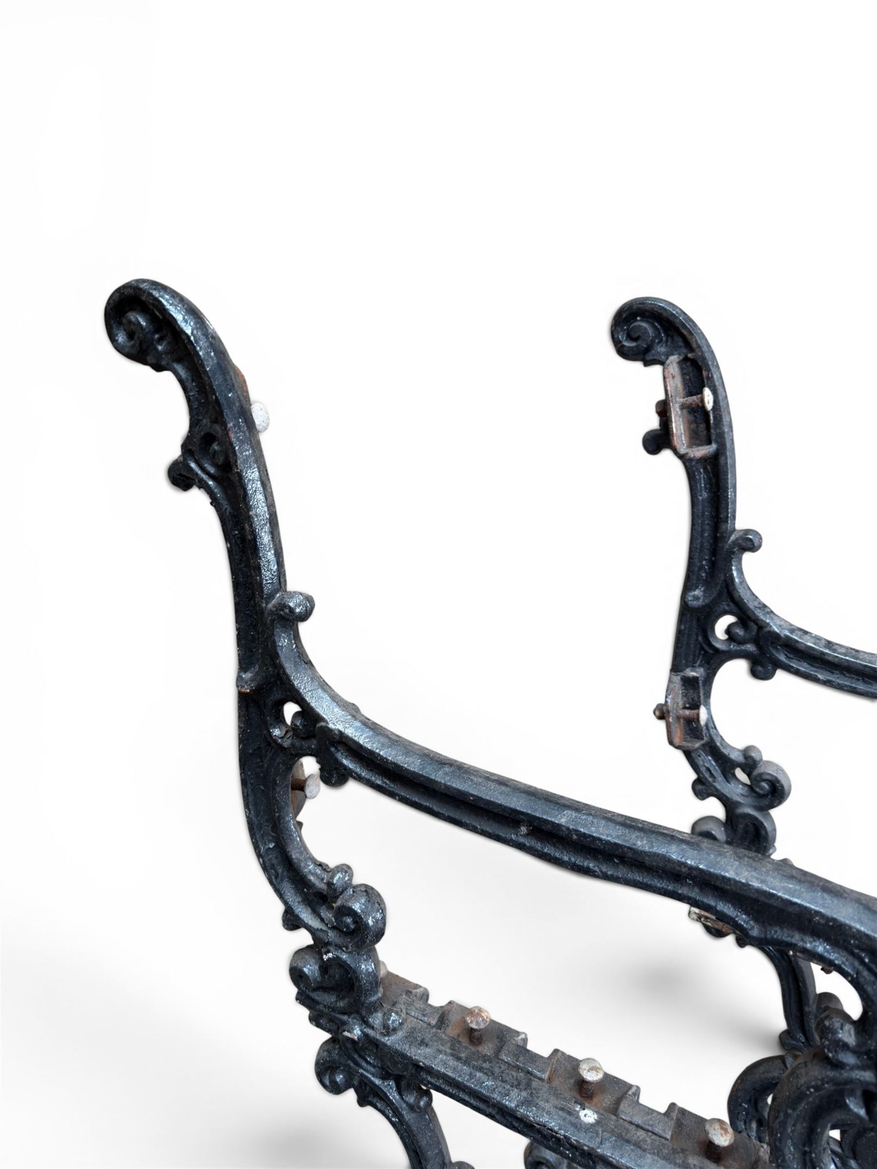 Carron Foundry - two pairs of 19th century cast iron garden bench ends, ornate detail with arms and X shaped legs,finish in black paint, the design no. 110396, first registered 13 July 1857 (see illustration), width as desired
