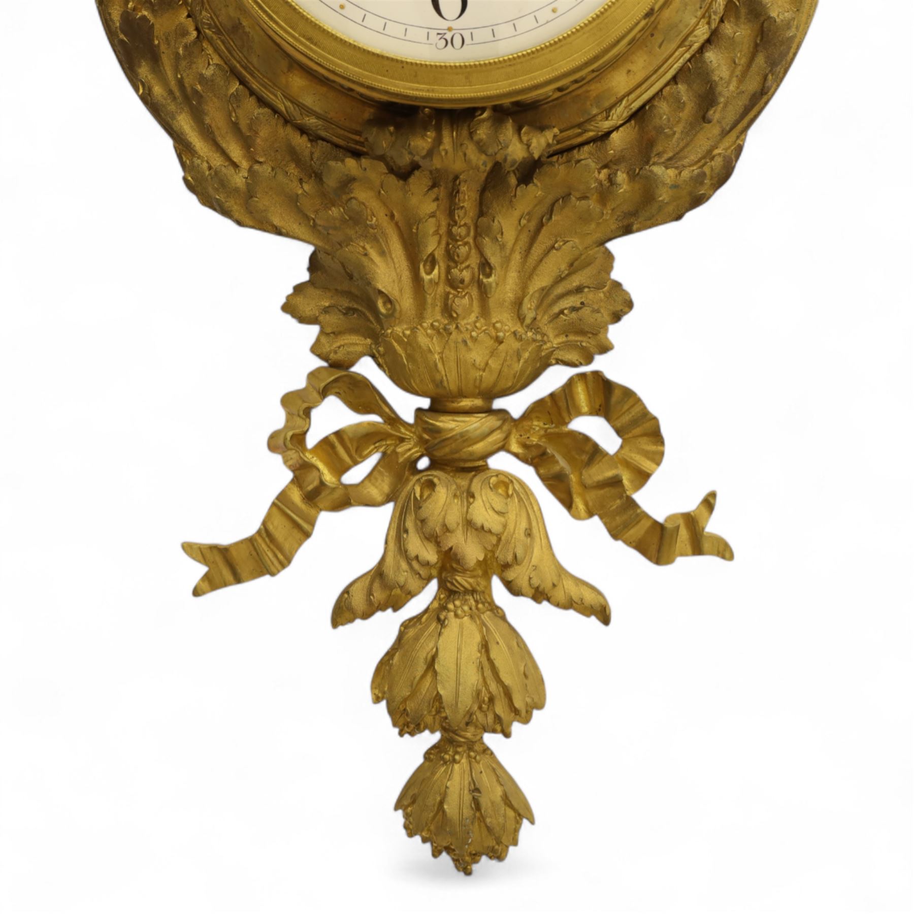 French- late 19th century cast brass and ormolu 8-day cartel wall clock, with a profusely decorated case comprising urn finials garland wreaths, ribbon bows and French cockerels, white enamel dial with minute track, Arabic numerals, garland swags and pierced gilt hands, twin train movement with a recoil anchor escapement and countwheel strike, striking the hours and half-hours on a bell. With pendulum and key.