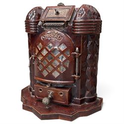Deville & Cie of Charleville - early 20th century Art Deco cast iron and burgundy enamel 'Cristal' wood burning stove, hinged vent over lattice glazed door and ash drawer, on shaped geometric base, circa 1920