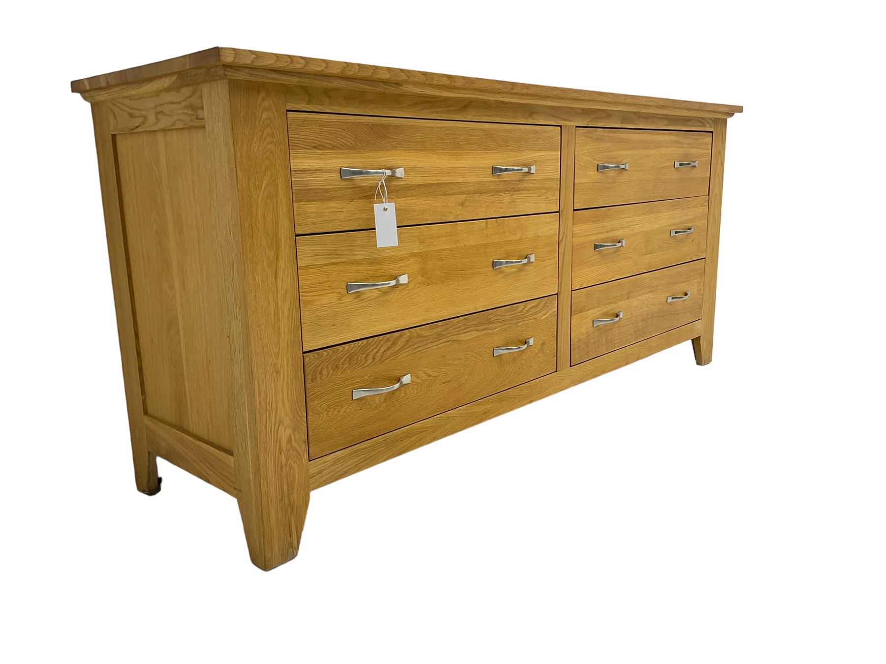 Contemporary wide oak straight-front chest, fitted with a bank of six drawers with chrome handles, on tapered feet