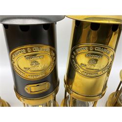 Four miners lamps, comprising Clanny miners lamp, with flip top and gauze protected by three rods, stamped E.T.W E-3, lamp with a gauze chamber protected by three rods, and two E. Thomas & Williams Ltd lamps, tallest example H26cm