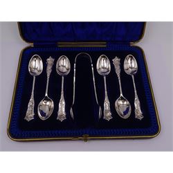Edwardian silver cream jug, of fluted helmet form, with angular handle and upon shaped foot, hallmarked Birmingham 1905, maker's mark indistinct, together with a set of six Edwardian silver teaspoons and a pair of sugar tongs, all with scrolling embossed decoration and engraved monogram, hallmarked Joseph Rodgers & Sons, Sheffield 1903, within tooled leather fitted case, jug including handle H9cm 