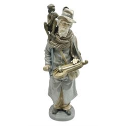 Lladro figure, Organ Grinder, modelled as an elderly man playing his hurdy gurdy instrument with a monkey seated upon his shoulder, sculpted by Salvador Furió, with original box, no 5046, year issued 1980, year retired 1981, H34cm